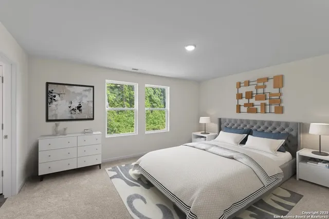 a bedroom with a bed and a large window