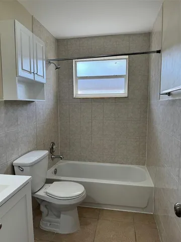 a bathroom with a toilet a sink and bathtub