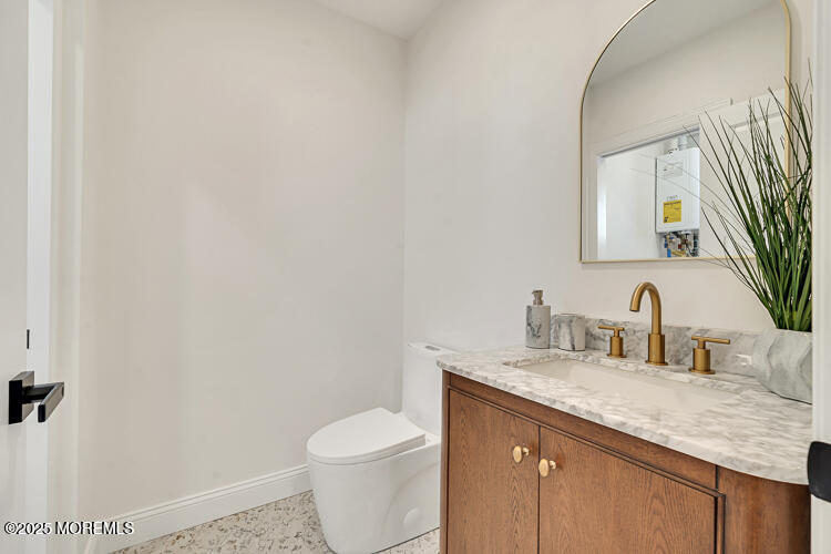 24 Surf Street Sea Bright, NJ 07760 - Photo 12 of 47 a bathroom with a granite countertop sink mirror vanity and toilet