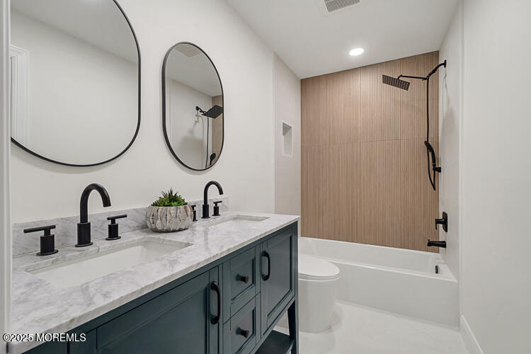 24 Surf Street Sea Bright, NJ 07760 - Photo 19 of 47 a bathroom with a sink and a mirror