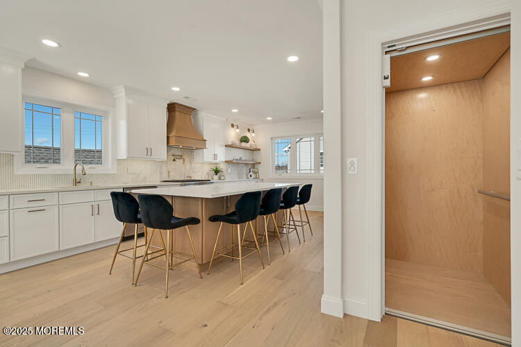 24 Surf Street Sea Bright, NJ 07760 - Photo 4 of 47 a kitchen with a sink and chairs