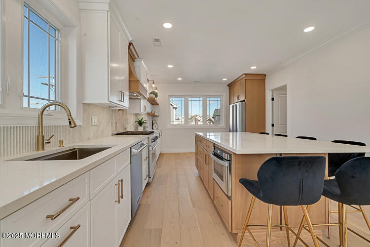 24 Surf Street Sea Bright, NJ 07760 - Photo 5 of 47 a kitchen with stainless steel appliances granite countertop a sink and a stove