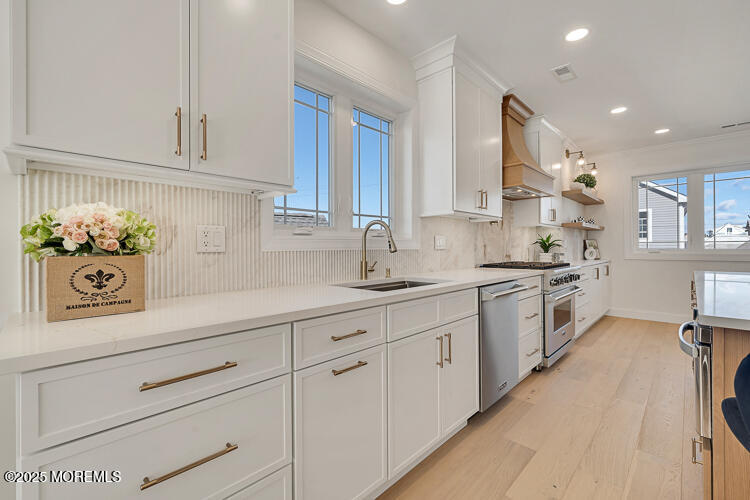 24 Surf Street Sea Bright, NJ 07760 - Photo 6 of 47 a kitchen with granite countertop white cabinets and white appliances