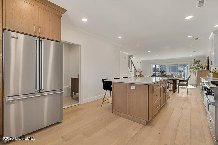 24 Surf Street Sea Bright, NJ 07760 - Photo 7 of 47 a kitchen with stainless steel appliances refrigerator dining table and chairs