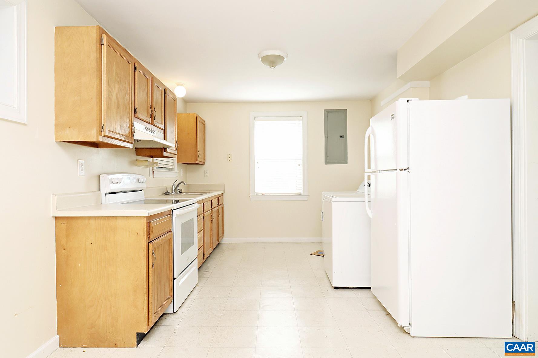 219 Shamrock Road, Unit B Charlottesville, VA 22903 - Photo 5 of 7 a kitchen with a sink a refrigerator and cabinets