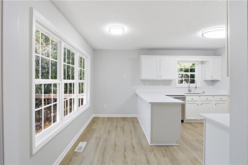 10 Mariner Way Acworth, GA 30102 - Photo 7 of 20 a kitchen with cabinets a sink and wooden floor