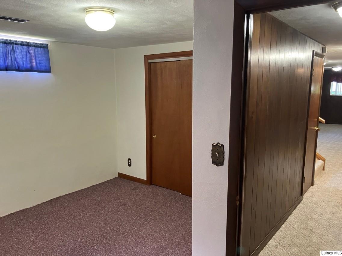328 North Illinois Street Camp Point, IL 62320 - Photo 13 of 22 an empty room with closet and wooden floor