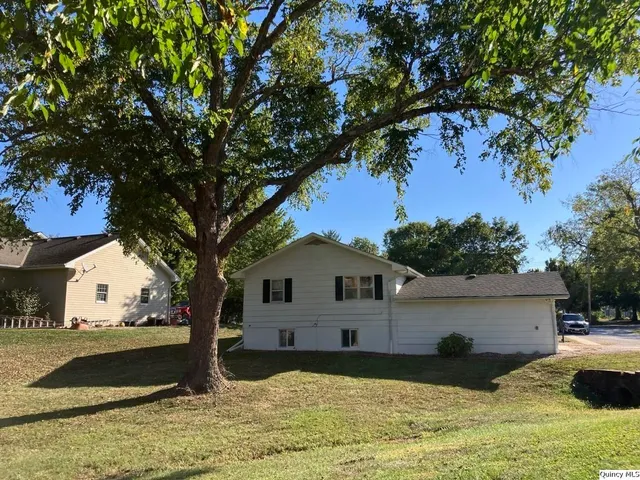 a view of a house with wooden fence