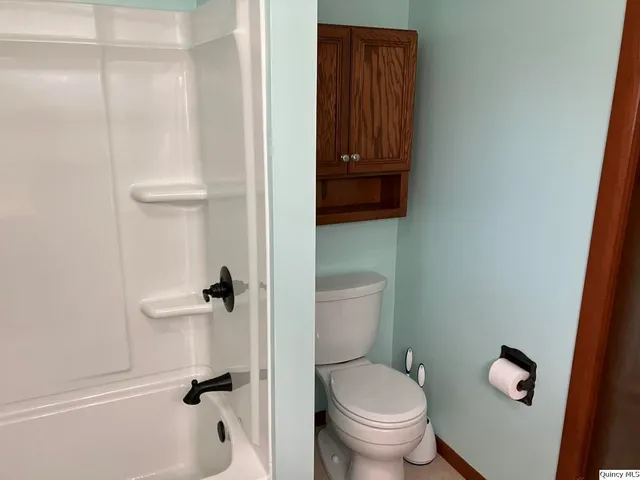 a white toilet sitting next to a bathroom sink