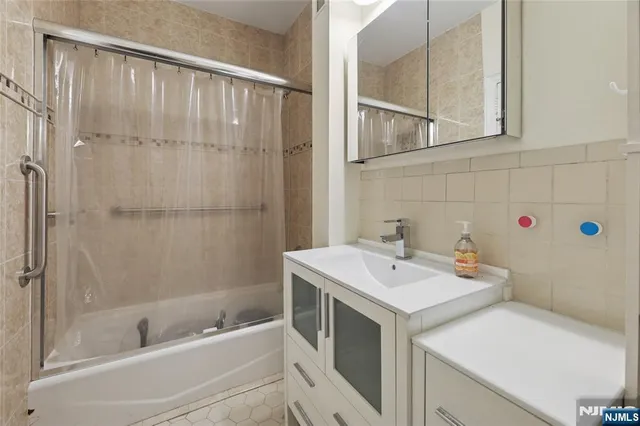 an empty room with wooden floor cabinet and windows