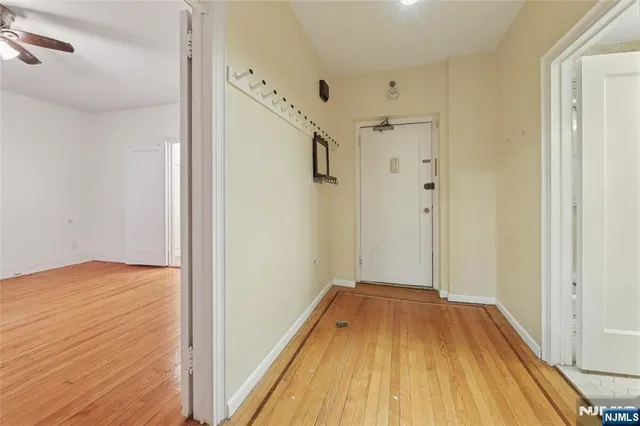 a kitchen with stainless steel appliances granite countertop a sink a stove and a white cabinets
