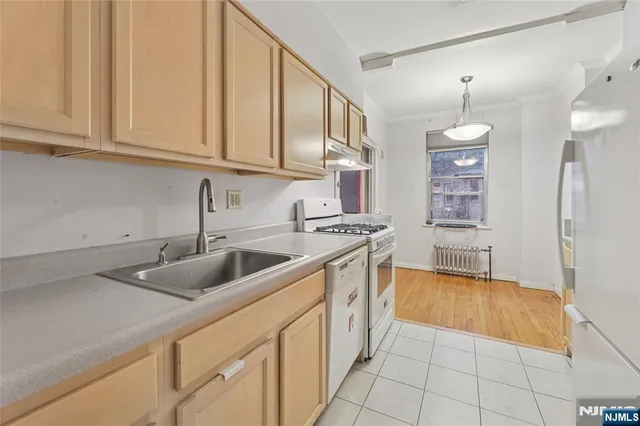 a view of empty room with wooden floor and fireplace