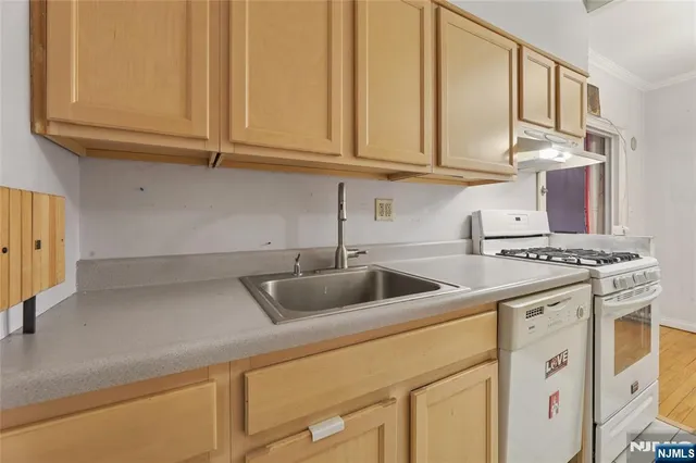 a view of empty room with wooden floor and fireplace