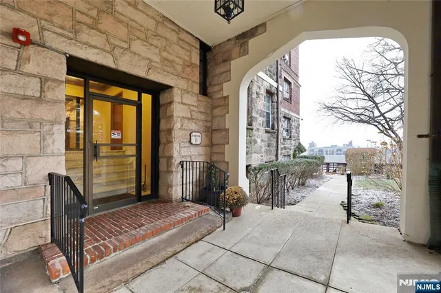 an empty room with wooden floor and ceiling fan