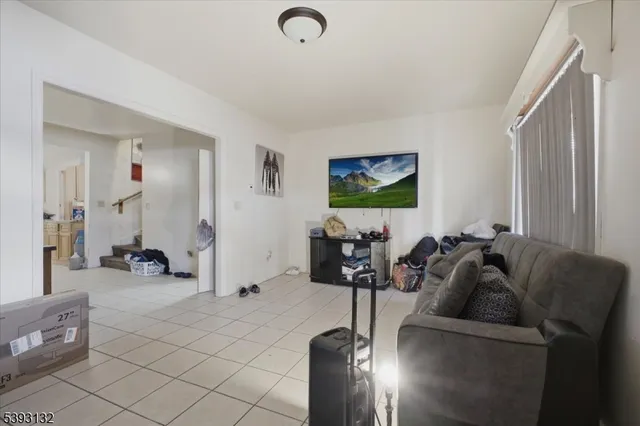 a living room with furniture gym equipment and a large window