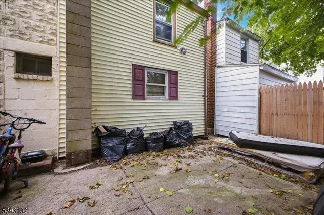 a view of a backyard with a table and chairs and wooden fence