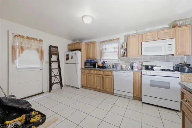 a kitchen with a white cabinets and white appliances