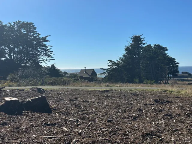 a view of dirt yard with mountain view