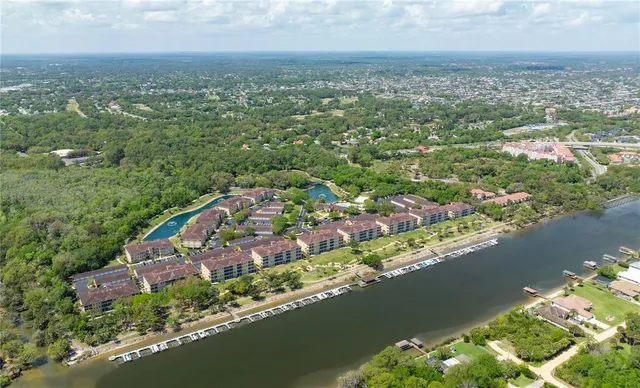 an aerial view of residential building with outdoor space and lake view