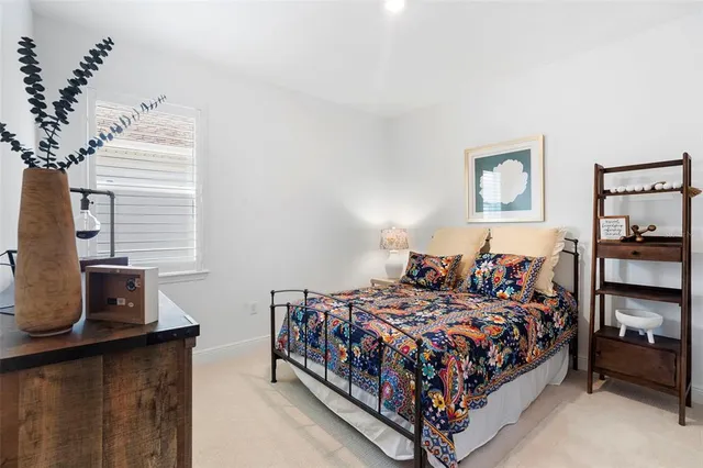 a bed sitting in a bedroom next to a window