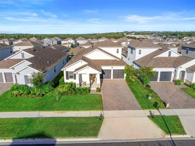 an aerial view of residential houses with outdoor space