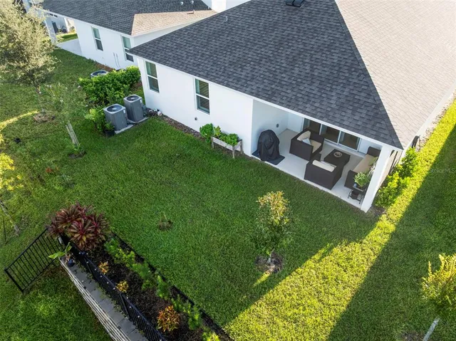 a front view of a house with a yard and potted plants
