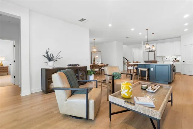 a living room with fireplace furniture and a wooden floor