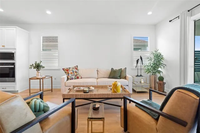a living room with furniture and potted plant