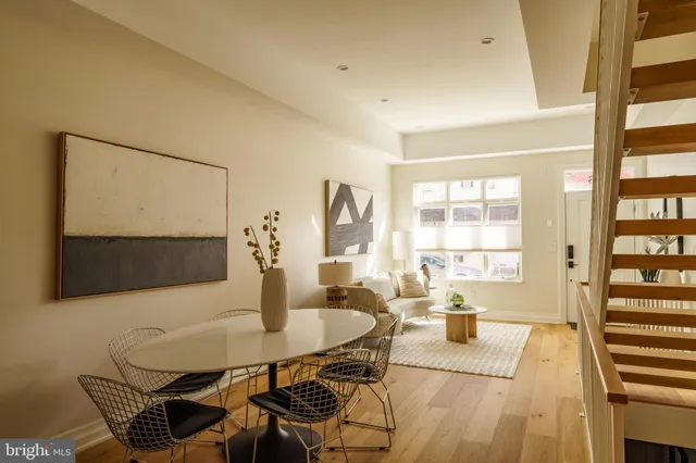 a dining room with furniture and wooden floor