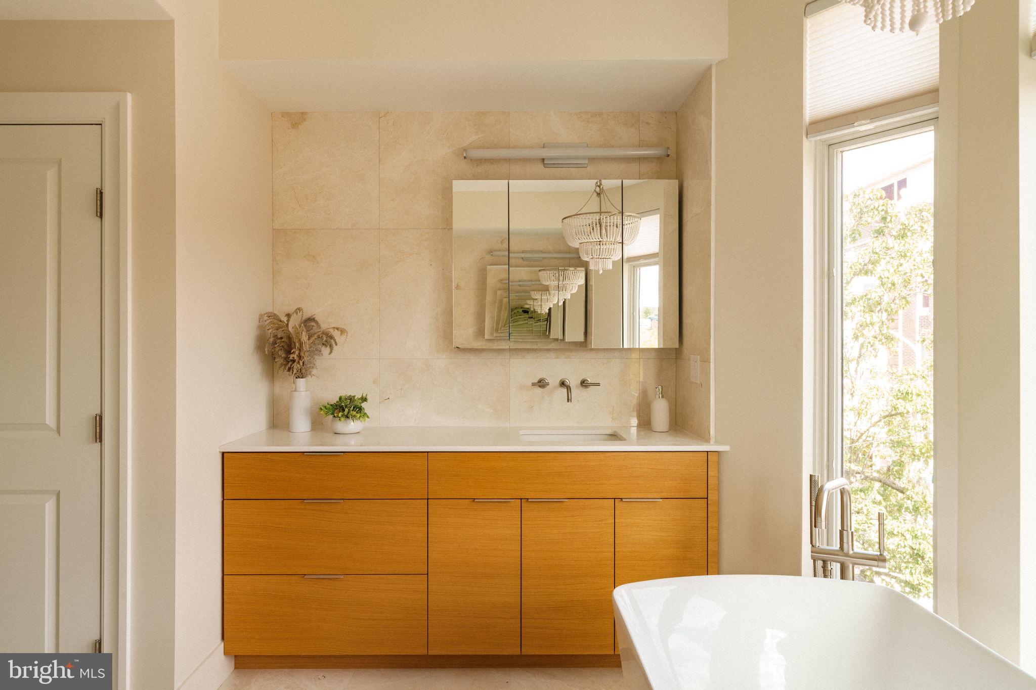 2104 Naudain Street Philadelphia, PA 19146 - Photo 27 of 56 a bathroom with a sink and a mirror