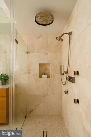 a spacious bathroom with a granite countertop sink a mirror and a bathtub