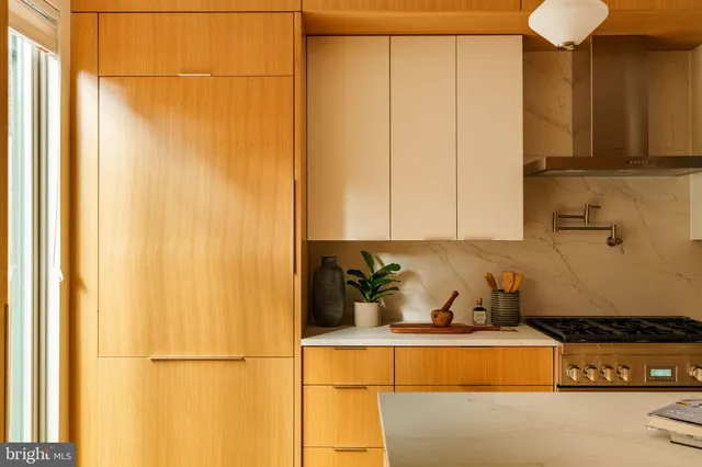 a kitchen with a refrigerator and cabinets
