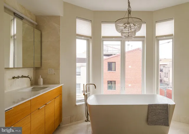 a living room with furniture and two window