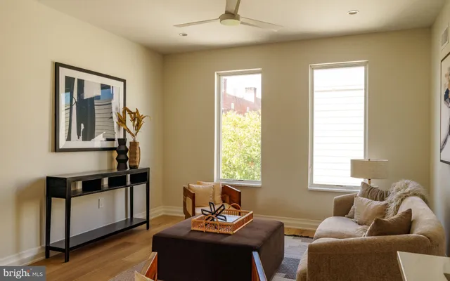 a living room with furniture and a wooden floor
