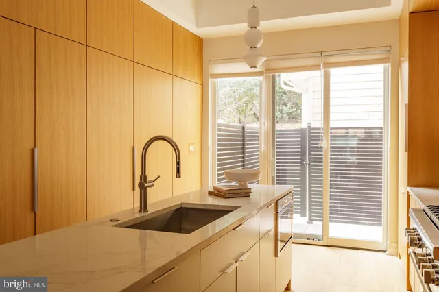 a kitchen with a sink a counter top space and a window