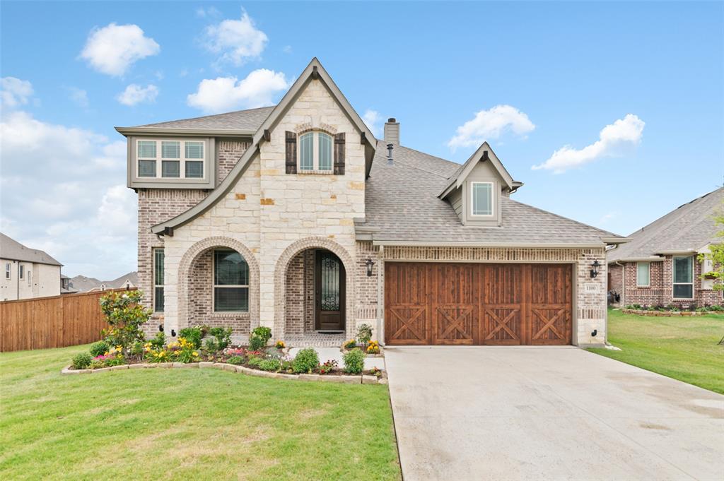 1100 Misty Ridge Drive Justin, TX 76247 - Photo 1 of 1 a front view of a house with a yard and garage