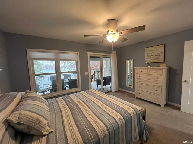 a large white bed in a bedroom next to a cabinet