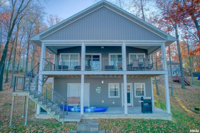 a view of a house with a yard and wooden fence