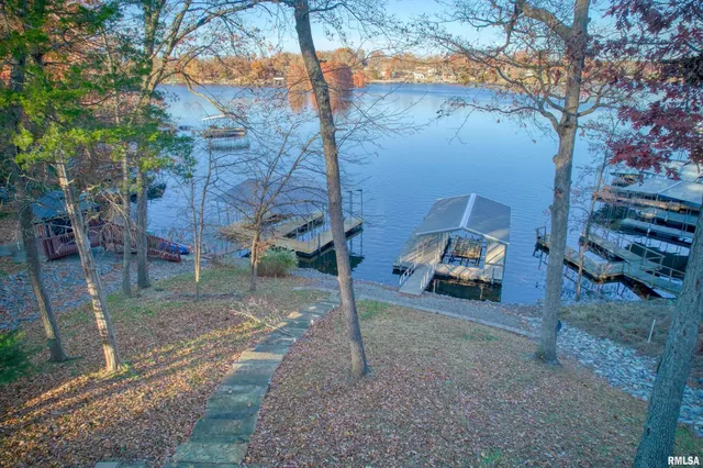 an aerial view of a house with a lake view