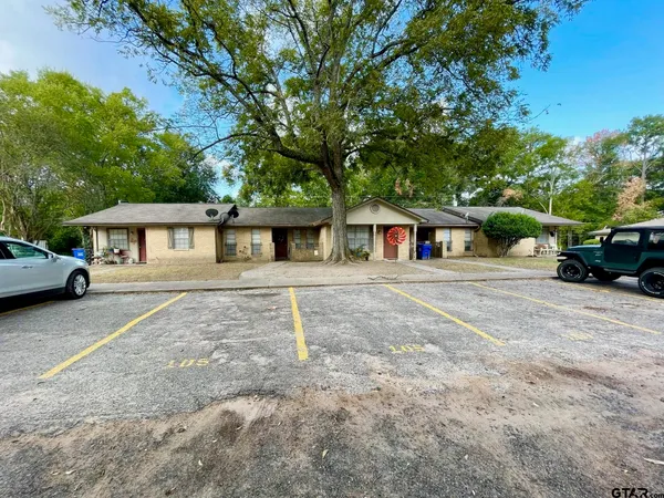 a car parked in front of house with a yard