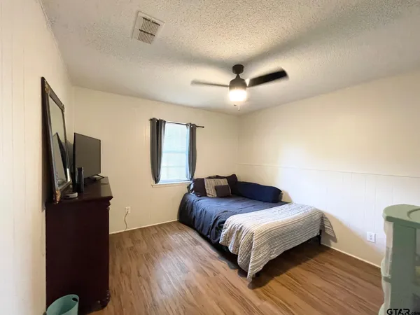 a bathroom with a sink mirror vanity and toilet