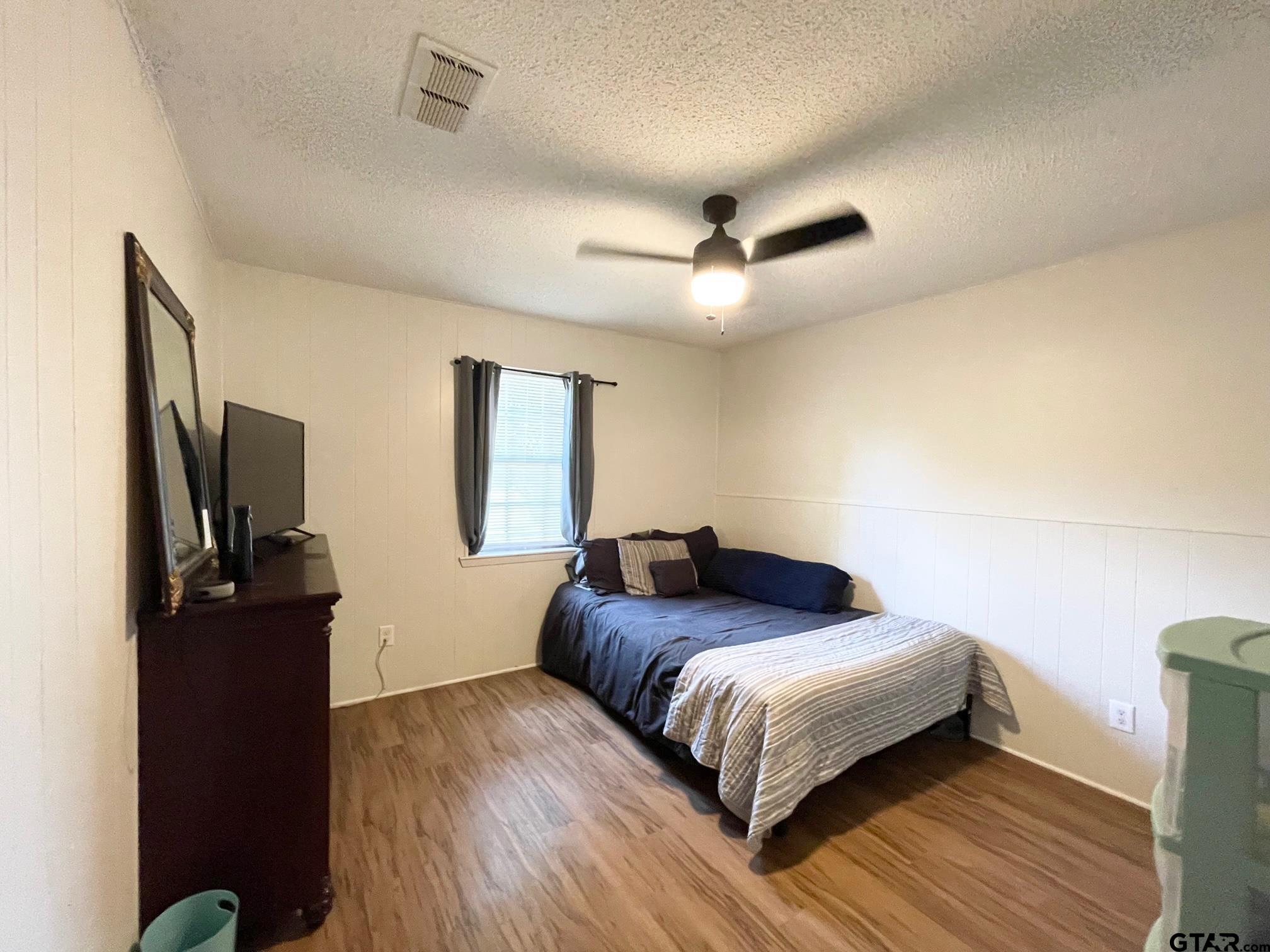 2301 North 6th Street Crockett, TX 75835 - Photo 11 of 12 a bedroom with a bed window and a flat screen tv