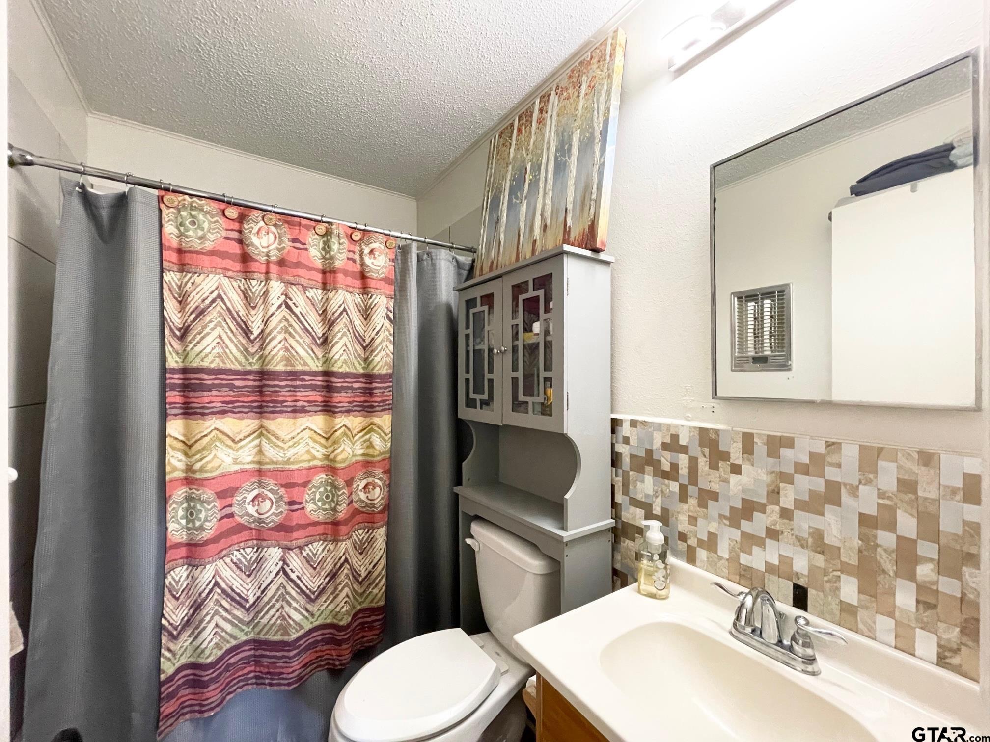 2301 North 6th Street Crockett, TX 75835 - Photo 12 of 12 a bathroom with a sink mirror vanity and toilet