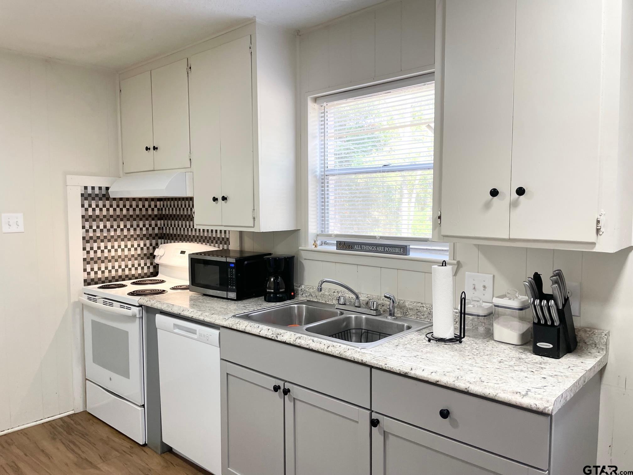 2301 North 6th Street Crockett, TX 75835 - Photo 9 of 12 a kitchen with sink cabinets and window