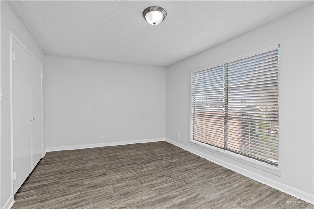 2425 Barnard Road, Unit 6C Brownsville, TX 78520 - Photo 7 of 15 Spare room with dark wood-type flooring and a textured ceiling