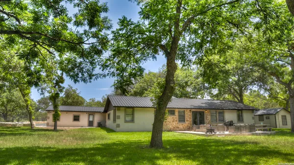 a bathroom with a granite countertop sink and a toilet