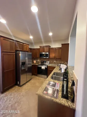 a kitchen with refrigerator and microwave