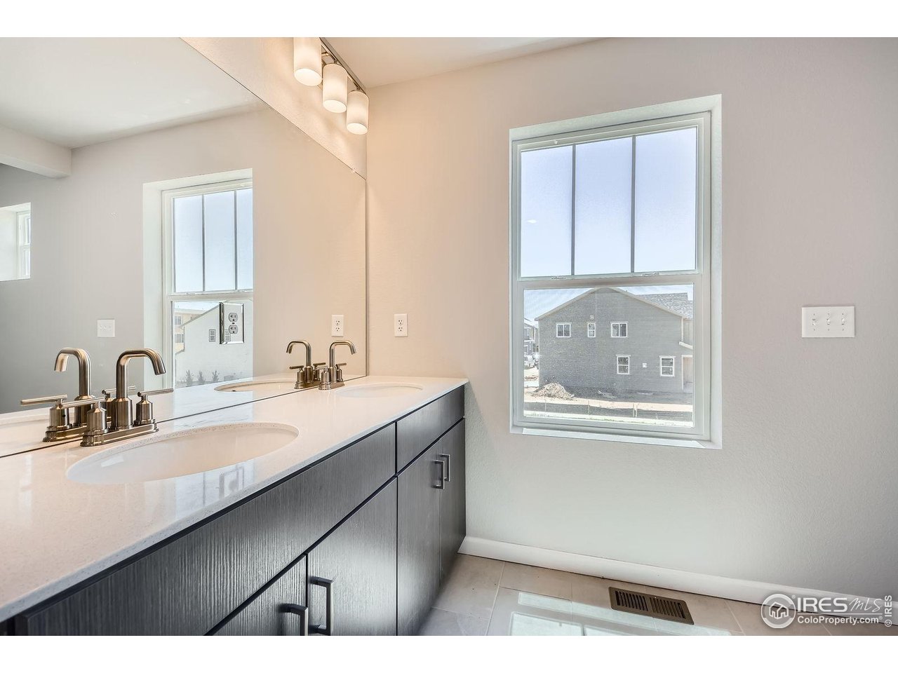 2290 Walbridge Road Fort Collins, CO 80524 - Photo 16 of 24 Primary bathroom with double sinks and a walk-in shower.