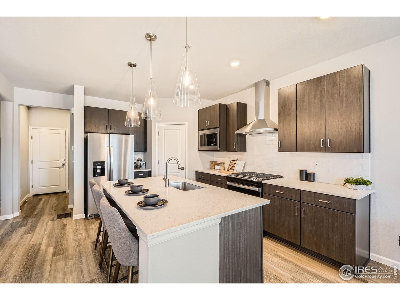 2290 Walbridge Road Fort Collins, CO 80524 - Photo 3 of 24 Upgraded kitchen with slide-in gas range, vented hood and included fridge!