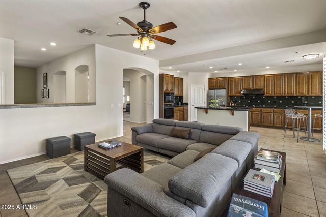 a living room with furniture and kitchen view
